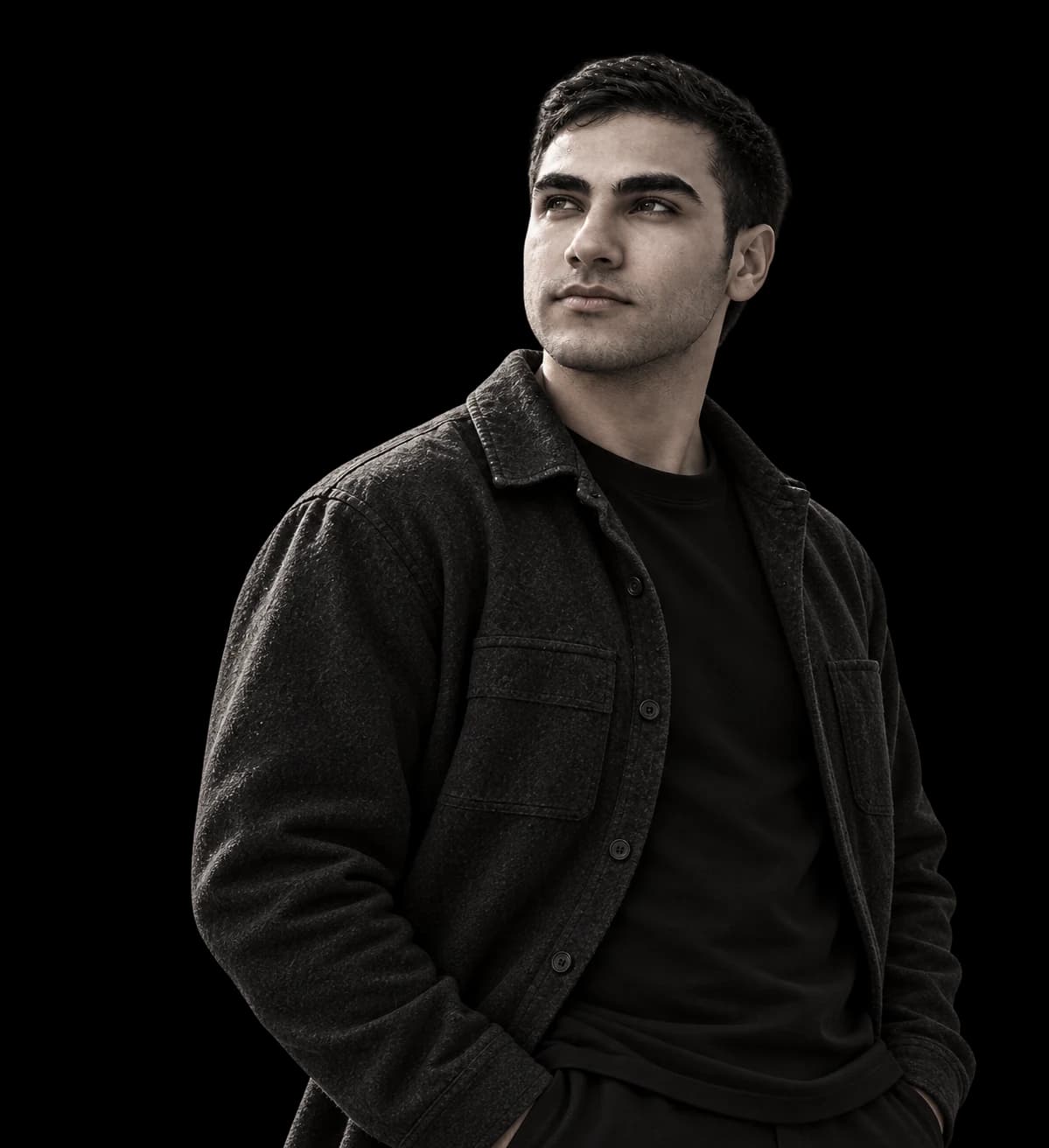 Muhammed Bodruk wearing a charcoal overshirt and looking toward the light